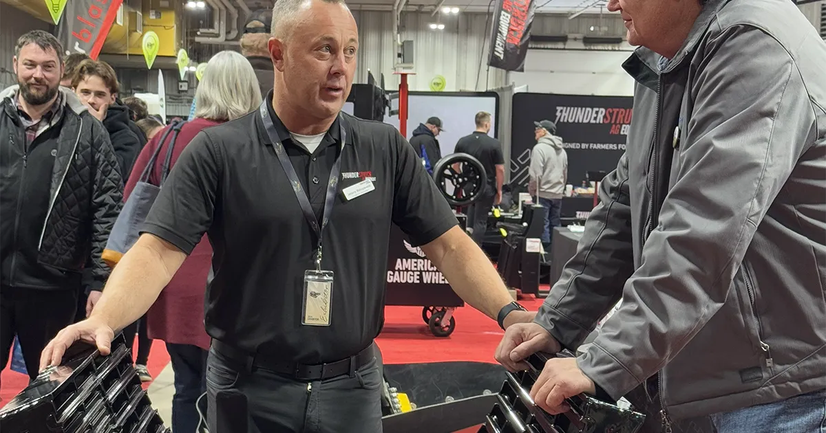 Jeremy Matuszewski talking to farmer at trade show