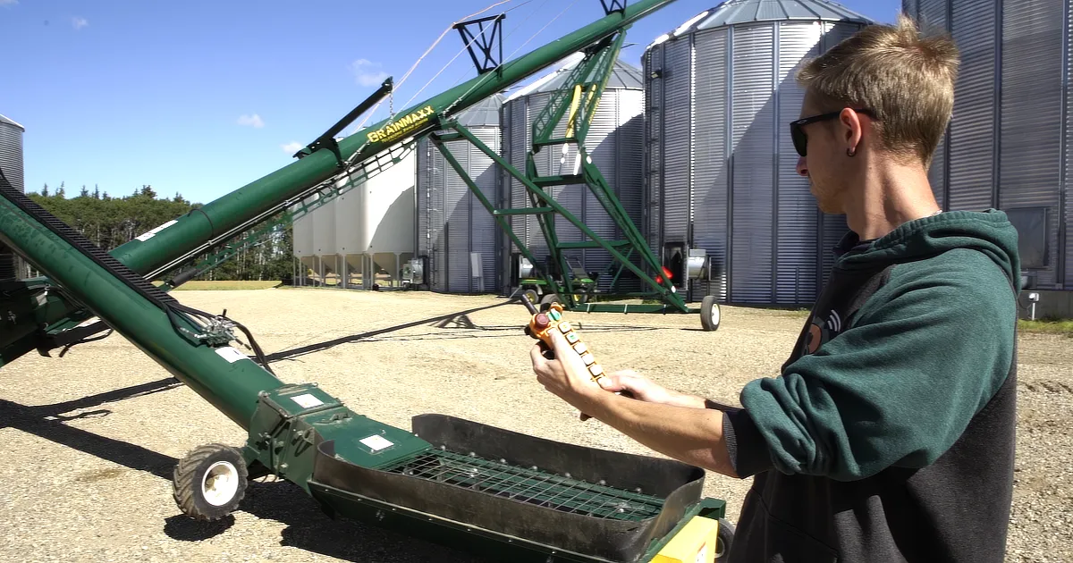 RcFarmArm operator controlling auger wirelessly