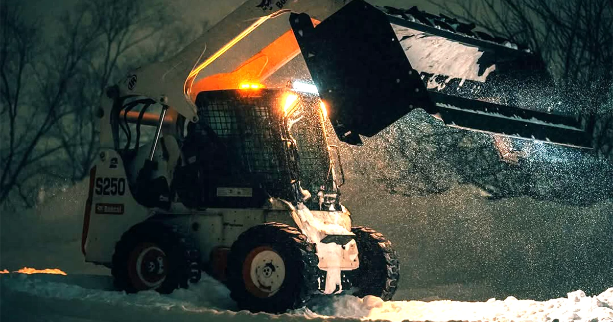 skid-steer equipped with Jenkins Iron and Steel snow pusher