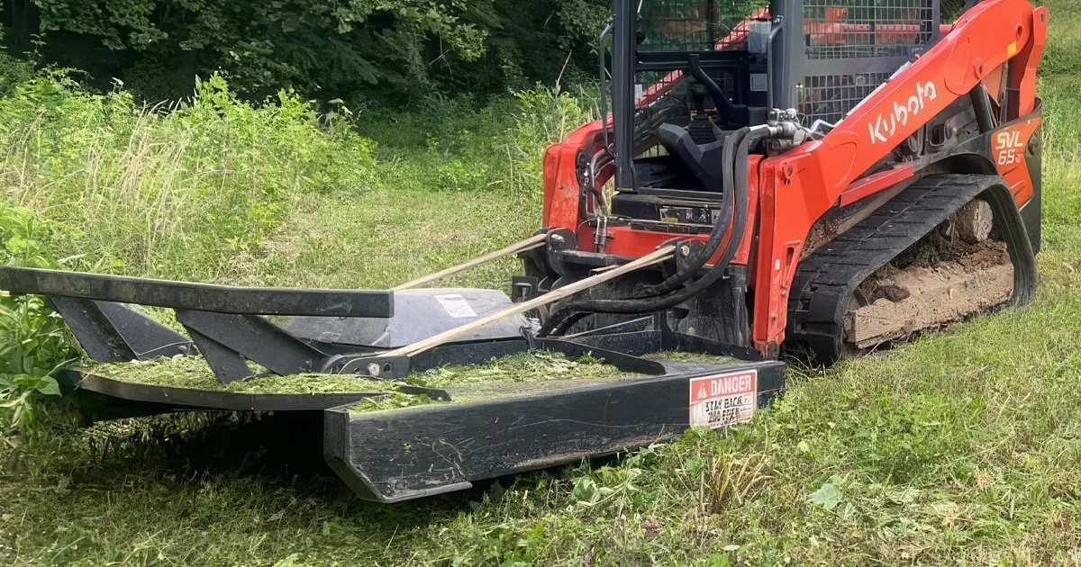 Skid-steer with Jenkins brush mower attachment