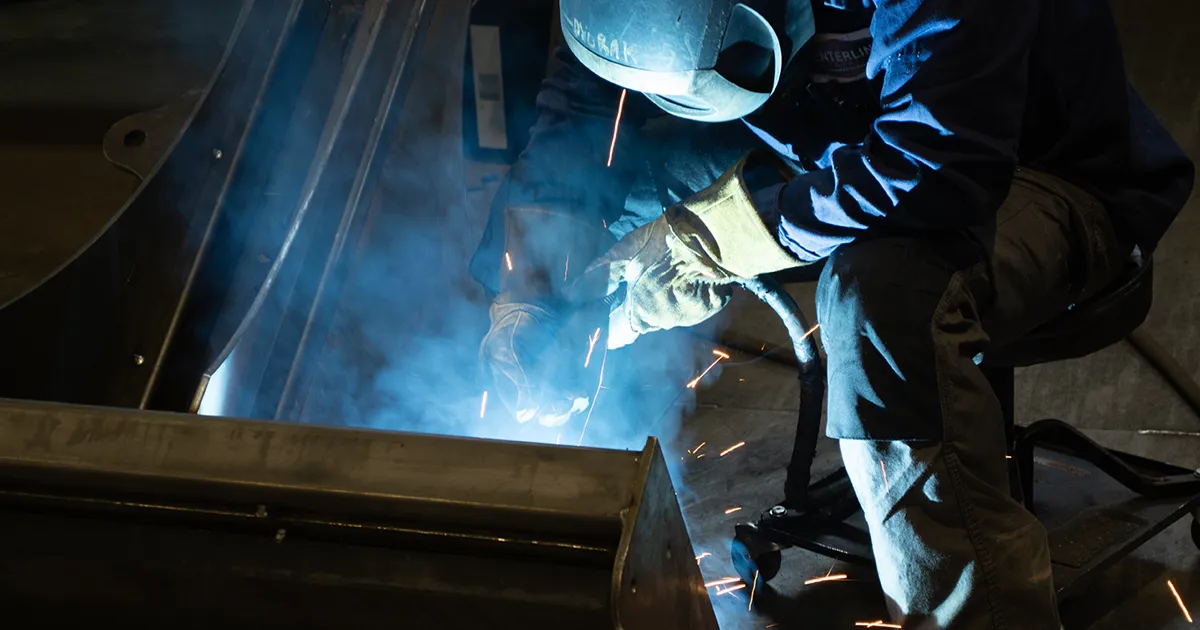 welder working on Jenkins Iron and Steel attachment