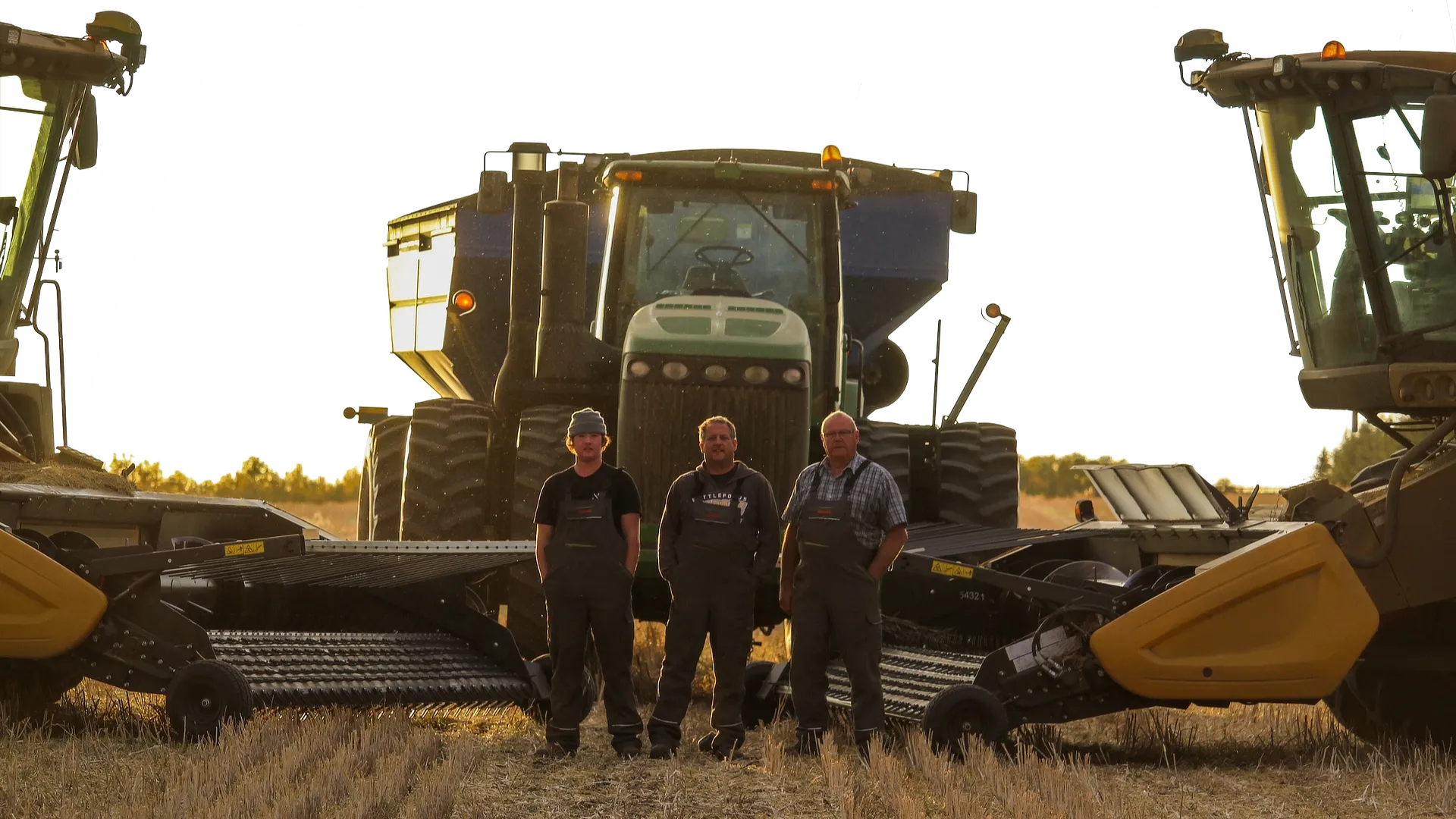 Schergain inventors standing in front of combines