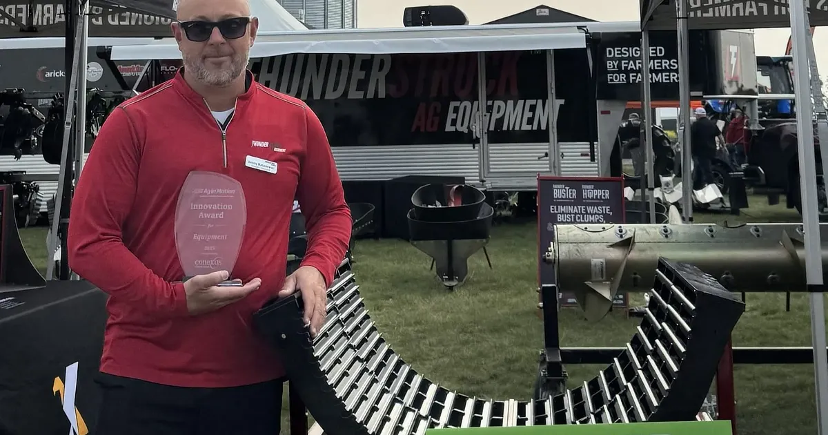 Jeremy Matuszewskii holding award standing next to Razors Edge Concaves
